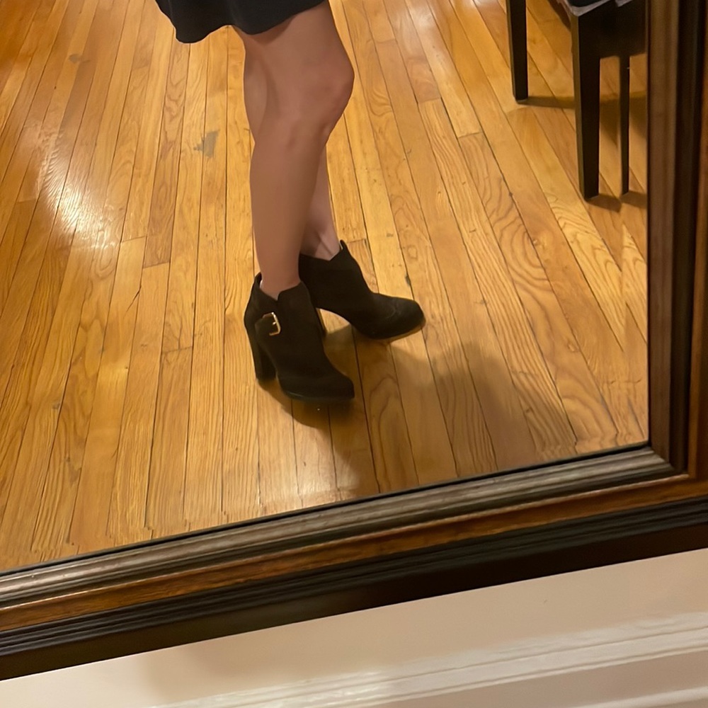 Prada brown suede ankle boots with gold buckle and perforated design .